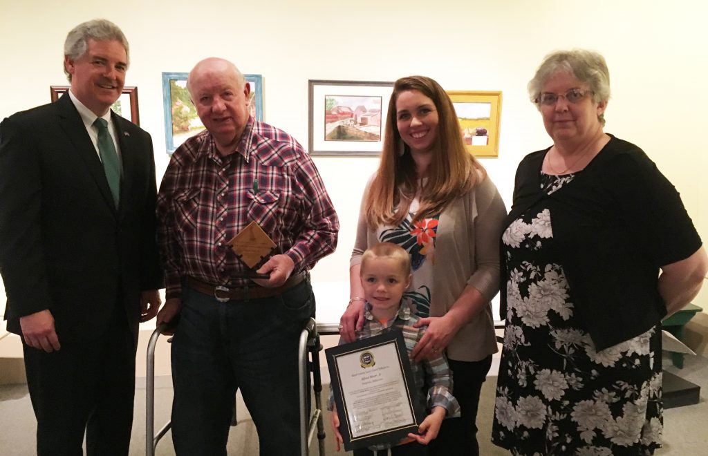 DNREC Secretary Shawn M. Garvin congratulates Kent County Agricultural Award honoree Alfred Moor Jr. of Smyrna, with his granddaughter-in-law Hallie Moor, great-grandson Everett Moor, and Gail Montgomery. Delaware Association of Conservation Districts also honors Legislator of the Year